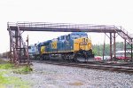 CSX 598 leads a southbound train parked under the pedestrian overpass (in a light rain)